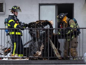Windsor firefighters keep the eye on a burning bed frame after responding to a fire on the fifth floor of the Shanbrook Apartments at 935 Goyeau Street, Friday January 09, 2015. (NICK BRANCACCIO/The Windsor Star)