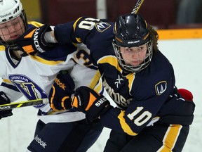 University of Windsor's Krystin Lawrence, right, tangles with Laurentian's Megan Burr in OUA women's hockey action at South Windsor Arena, January 9, 2015. (NICK BRANCACCIO/The Windsor Star)