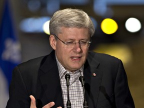 Prime Minister Stephen Harper addresses a news conference to announce support to preserve the heritage of the city, Tuesday, Dec.16, 2014 in Quebec City. THE CANADIAN PRESS/Jacques Boissinot