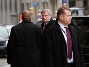 Prime Minister Stephen Harper is escorted by security in a file photo. THE CANADIAN PRESS/Sean Kilpatrick