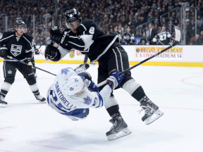Kings defenceman Drew Doughty, right, hits Mike Santorelli of the Toronto Maple Leafs in front of Mike Richards during the first period at Staples Center in Los Angeles. (Photo by Harry How/Getty Images)