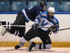 Harrow's Jordan Ursu, left, collides with Villanova's Cole Welsh during high school hockey at the Vollmer Centre in LaSalle. (DAN JANISSE/The Windsor Star)