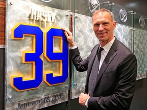 Former Buffalo Sabre Dominik Hasek stands next to a plaque with his newly retired  number in the enterance way to the Buffalo Sabres locker-room prior to their game against the Detroit Red Wings at the First Niagara Center. (AP Photo/The Buffalo News, Harry Scull, Jr.)