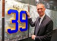Former Buffalo Sabre Dominik Hasek stands next to a plaque with his newly retired  number in the enterance way to the Buffalo Sabres locker-room prior to their game against the Detroit Red Wings at the First Niagara Center. (AP Photo/The Buffalo News, Harry Scull, Jr.)