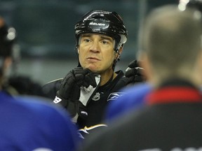 Flames defenceman Steve Staios, centre, takes a break at practice at the Saddledome in 2010.(Colleen De Neve/Calgary Herald)