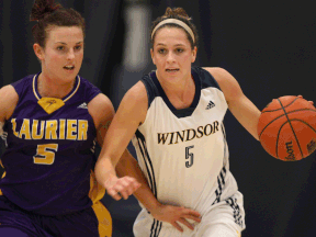 Windsor's Kristine Lalonde, right, dribbles the ball up court while being defended by Laurier's Nicole Morrison during OUA women's basketball at the St. Denis Centre Saturday. (DAX MELMER/The Windsor Star)