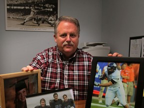 Proud dad Mike Willson, has plenty of inspiration on his office desk - photographs of children, Rachel, 21, twins Greg, left, and Eric, 26, and Luke, 25, Tuesday January 27, 2015.  Luke Willson and his brothers played football with Essex Ravens, centre, and with Rice University, right.  Luke Willson will be playing with Seattle Seahawks in Sunday's Super Bowl.  (NICK BRANCACCIO/The Windsor Star)