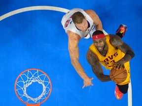 Cleveland's LeBron James, right, goes up for a shot against Blake Griffin of the Clippers in Los Angeles.  (AP Photo/Mark J. Terrill)