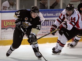 Vipers Manny Silverio, left, controls the puck as Lambton Shores Predators Brendan Trottier chases during first period of GOJHL action at Vollmer Centre, Wednesday January 28, 2015. (NICK BRANCACCIO/The Windsor Star)