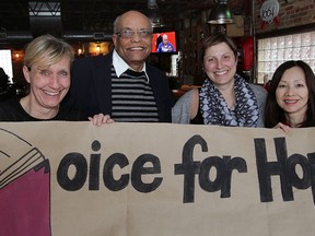 Voice for Hope Inc. members Brenda Taylor, left, Merideth McGrory, Beyene Haile and Terry Chow, right,  prepare a large poster during a fundraiser held at Rock Bottom, Thursday January  29, 2015. (NICK BRANCACCIO/The Windsor Star)