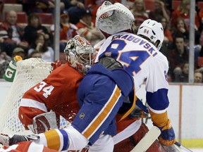 New York's Mikhail Grabovski, right, crashes into Detroit goalie Petr Mrazek during the first period Saturday in Detroit. (AP Photo/Carlos Osorio)