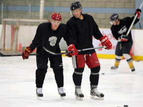 Brit Ouellette, left, and Travis Ouellette take a break at Tecumseh Arena in August. (TYLER BROWNBRIDGE/The Windsor Star)