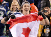 Seattle Seahawks tight end Luke Willson holds up a Canadian flag after the NFL Super Bowl XLVIII football game against the Denver Broncos, Sunday, Feb. 2, 2014, in East Rutherford, N.J. The Seahawks won 43-8. (AP Photo/Kathy Willens)