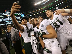 Michigan State Spartans take a team selfie after defeating the Baylor Bears during the Goodyear Cotton Bowl Classic at AT&T Stadium on January 1, 2015 in Arlington, Texas.  (Photo by Sarah Glenn/Getty Images)
