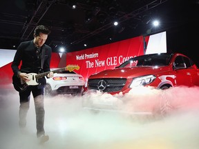 Mayer Hawthorne of Mayer Hawthorne and The County helps Mercedes-Benz introduce the GLE 63 Coupe (L) and the GLE 450 AMG Coupe at the North American International Auto Show (NAIAS) on January 11, 2015 in Detroit, Michigan. The auto show will open to the public January 17-25.  (Photo by Scott Olson/Getty Images)