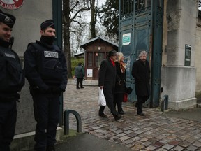 PARIS, FRANCE - JANUARY 15:  Mourners leave the funeral service of Charlie Hebdo cartoonist Georges Wolinski at Père Lachaise Crematorium on January 15, 2015 in Paris, France. Cartoonist Georges Wolinski was killed in last weeks terrorist attack on satirical newspaper Charlie Hebdo.  (Photo by Christopher Furlong/Getty Images)