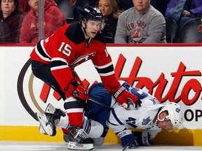 Toronto's Tyler Bozak, right, is tripped by Tuomo Ruutu of the New Jersey Devils during the first period at the Prudential Center Wednesday in Newark, New Jersey.  (Bruce Bennett/Getty Images)