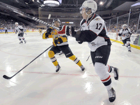 Windsor's Logan Stanley, right, clears the puck Saturday in Erie against the Otters. (GREG WOHLFORD/Erie Times News)