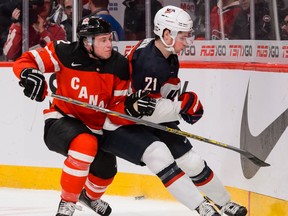 Detroit's Red Wings' prospects Joe Hicketts of Canada and Dylan Larkin of the USA compete against each other at the 2015 world junior tourney. Currently playing for the USA at the world championship, Larkin, Detroit's top choice in the 2014 NHL entry draft, is weighing whether to turn pro with the Wings.