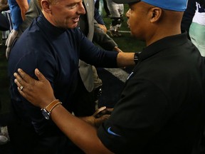 Detroit coach Jim Caldwell, right, shakes hands with Dallas coach Jason Garrett of the Dallas Cowboys after the wild-card game at AT&T Stadium Sunday in Arlington, Texas.  (Photo by Sarah Glenn/Getty Images)