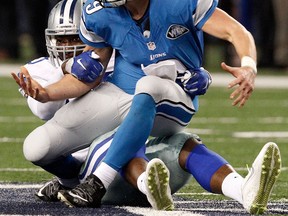 Dallas Cowboys defensive end Demarcus Lawrence, left, sacks Detroit Lions quarterback Matthew Stafford during the second half of  the wild-card playoff gamee Sunda. (AP Photo/Brandon Wade)