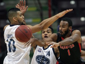 Brampton's Akeem Scott, right, loses the ball against Windsor's Kevin Loiselle, left, and Gary Gibson in NBL of Canada action from the WFCU Centre Thursday. (NICK BRANCACCIO/The Windsor Star)