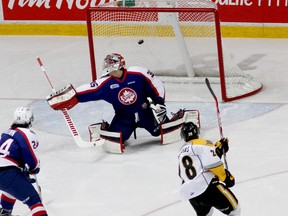 Sarnia's Josh Defarias (28) scores a goal in the first period against Windsor Spitfires goalie Brendan Johnston, Sunday, Jan. 25, 2015, at the WFCU Centre. (RICK DAWES/The Windsor Star)