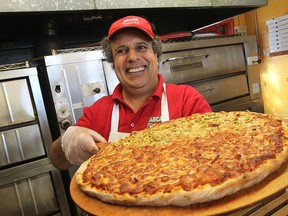 Bob Abumeeiz, owner of Arcata Pizzeria on Dougall Avenue prepares a pizza on January 27, 2015.   (JASON KRYK/The Windsor Star)