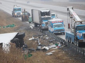 A transport truck rests on its side after flipping over on the 401 near Puce Road on Saturday, Jan. 3, 2014. (DAX MELMER/The Windsor Star)