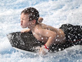 Gavin Langlois, 7, takes a ride on the WaveRider at Adventure Bay, Sunday, Jan. 18, 2015.  Adventure Bay celebrated it's first birthday Sunday with free cupcakes, hotdogs, a photo booth, and music by Beebo.  (DAX MELMER/The Windsor Star)