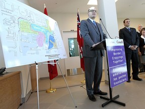 Mayor Drew Dilkens, MP Jeff Watson, Garfield Dales and MPP Kathryn McGarry (left to right) take part in an event to mark the opening of the renovated commercial truck lanes at the tunnel exit in Windsor on Tuesday, January 27, 2015.    (TYLER BROWNBRIDGE/The Windsor Star)
