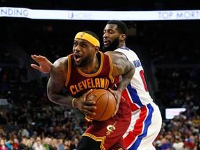 Cleveland's LeBron James, left, drives past Detroit's Andre Drummond in the second half Tuesday in Auburn Hills, Mich. (Paul Sancya/The Associated Press)