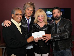 WINDSOR, ON. JANUARY 28, 2015. The Unemployed Help Centre and The Downtown Mission and Outreach organizations both received cheques for $15,000 thanks to the Sleighing Hunger fundraising campaign. Chandra Dass, (L), executive director of the Downtown Mission, and June Muir, CEO of Unemployed Help Centre pose with Jeff Burrows (second from left) and Jody Raffoul of The S'aint's who performed a charity concert at Caesars Windsor. An additional $15,000 was donated to the Outreach for Hunger in Chatham. (DAN JANISSE/The Windsor Star)