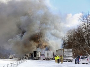 Emergency personnel watch as fireworks ignite at the scene of a fiery crash that closed both sides of Interstate 94, Friday, Jan. 9, 2015, between mile markers 88 and 92 in eastern Kalamazoo County, near Galesburg, Mich. State police say at least one person has died in the series of crashes involving roughly 150 vehicles, including at least two semi-trucks carrying fireworks and other hazardous materials. Authorities are blaming snow, wind and poor visibility in the crash. (AP Photo/Kalamazoo Gazette-MLive Media Group, Mark Bugnaski)