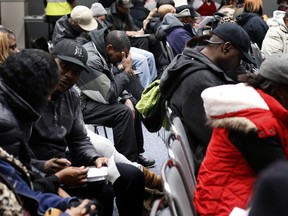 Homeowners sit in a conference room in Detroit's Cobo Center while waiting for their cases to be heard to avoid foreclosure from tax debts in Detroit Thursday, Jan. 29, 2015. Hundreds of Detroit homeowners at risk of losing their property are flocking to hearings that offer them a last-ditch chance to avoid foreclosure from tax debts. (AP Photo/Paul Sancya)