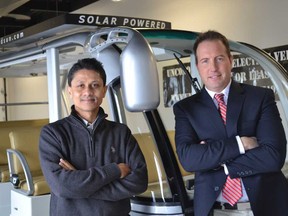 University of Windsor associate professor Narayan Kar, left, and Unconquered Sun founder and CEO Sean Moore, with a solar-powered, 11-passenger bus at Unconquered Sun on January 8, 2015, worked together to develop new solar powered electric vehicle technology that extends the range of solar-powered vehicles. (JULIE KOTSIS/The Windsor Star)