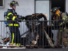 Windsor firefighters keep the eye on a burning bed frame after responding to a fire on the fifth floor of the Shanbrook Apartments at 935 Goyeau Street, Friday January 9, 2015. (NICK BRANCACCIO/The Windsor Star)