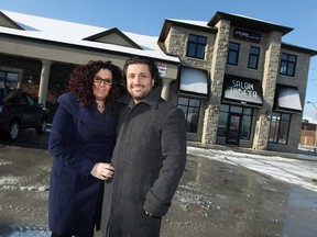 Hoda and Andre Abouasli are photographed in front of their salon which was derailed by a fire a on July 25, 2013. The two are pictured in this Jan. 6, 2015 file photo.