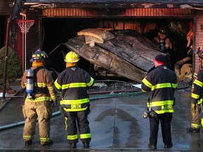 Fire crews work to put out a fire on the 1900 block of Fuller Crescent, Monday, Jan. 19, 2015.  The fire originated in the attached garage.  (DAX MELMER/The Windsor Star)