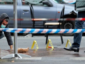 Police officers look for evidence after a shooting in Montrouge, outside Paris, Thursday, Jan.8, 2015. Two people were shot and gravely wounded at the southern edge of Paris, including a police officer, raising tensions a day after masked gunmen stormed the offices of a satirical newspaper and killed 12 people. (AP Photo/Christophe Ena)