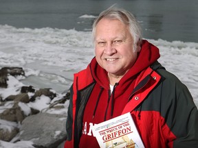 Cris Kohl, co-author of The Wreck of the Griffon with his Joan Forsberg, is pictured with his book on the banks of the Detroit River Sunday, Jan. 11, 2014, where the ship sailed in August 1679.  (DAX MELMER/The Windsor Star)