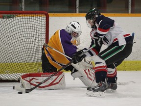 Holy Names Knights Chris Scalia shoots on Kingsville goaltender John Prout during  WECSSAA boys high school hockey action at South Windsor Arena on January 6, 2015 in Windsor, Ontario. (JASON KRYK/The Windsor Star)