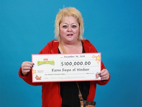 Karen Royse of Windsor shows the $100,000 prize cheque she won from playing Instant Crossword Tripler. (Handout / The Windsor Star)