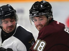 Lancers' Julian Luciani, left, tangles with Concordia's Dany Potvin in OUA men's hockey at South Windsor Arena Friday January 16, 2015. (NICK BRANCACCIO/The Windsor Star)