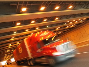 Lights illuminate trucks and automobiles as they pass through a tunnel on the Herb Gray Parkway, Friday, Jan. 2, 2015. (DAX MELMER/The Windsor Star)