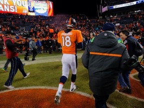 DENVER, CO - JANUARY 11:  Peyton Manning #18 of the Denver Broncos walks off the field after losing 24-13 to the Indianapolis Colts in a 2015 AFC Divisional Playoff game at Sports Authority Field at Mile High on January 11, 2015 in Denver, Colorado.  (Photo by Doug Pensinger/Getty Images)