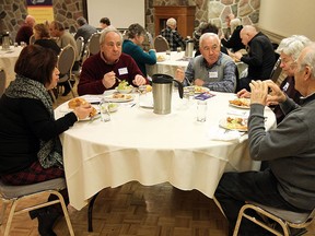 Nancy Rainelli, Mario Rainelli, John Ferraro, Jeannine Cradduck and Allan Cradduck (left to right) enjoy a free lunch hosted by the 100 Mile Peninsula Club at the Caboto Club in Windsor on Friday, January 30, 2015.  (TYLER BROWNBRIDGE/The Windsor Star)