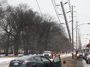 A hydro pole was snapped and a car heavily damaged during an accident Thursday, Jan. 29, 2015, on the Ojibway Parkway near the Windsor Raceway. The accident occurred just before 9:00 a.m. and the driver suffered non-life threatening injuries. (DAN JANISSE/The Windsor Star)