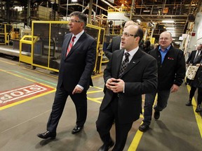 Ontario Finance Minister Charles Sousa, left, is given a tour by Nemak operations manager Brad Boutros during an announcement at the Nemak plant in Windsor on  January 19, 2015.    (TYLER BROWNBRIDGE/The Windsor Star)