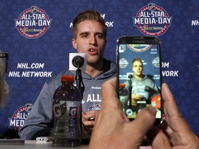 Belle River native Aaron Ekblad of the Florida Panthers answers a question as he is videoed by a reporter during media day at the NHL All-Star hockey weekend in Columbus, Ohio, Friday, Jan. 23, 2015. (AP Photo/Gene J. Puskar